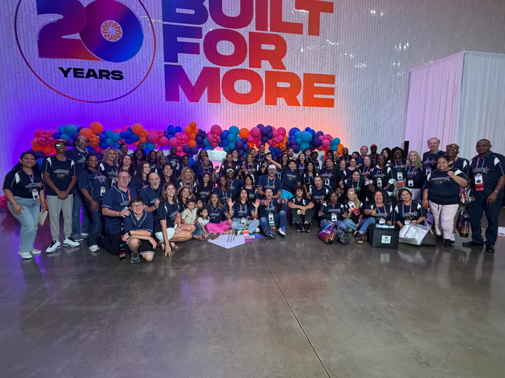 Team Ambit gathered together in front of the Built for More stage at Ambition 2026